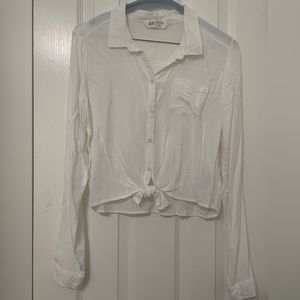 White blouse with front button closure and bow appliqué